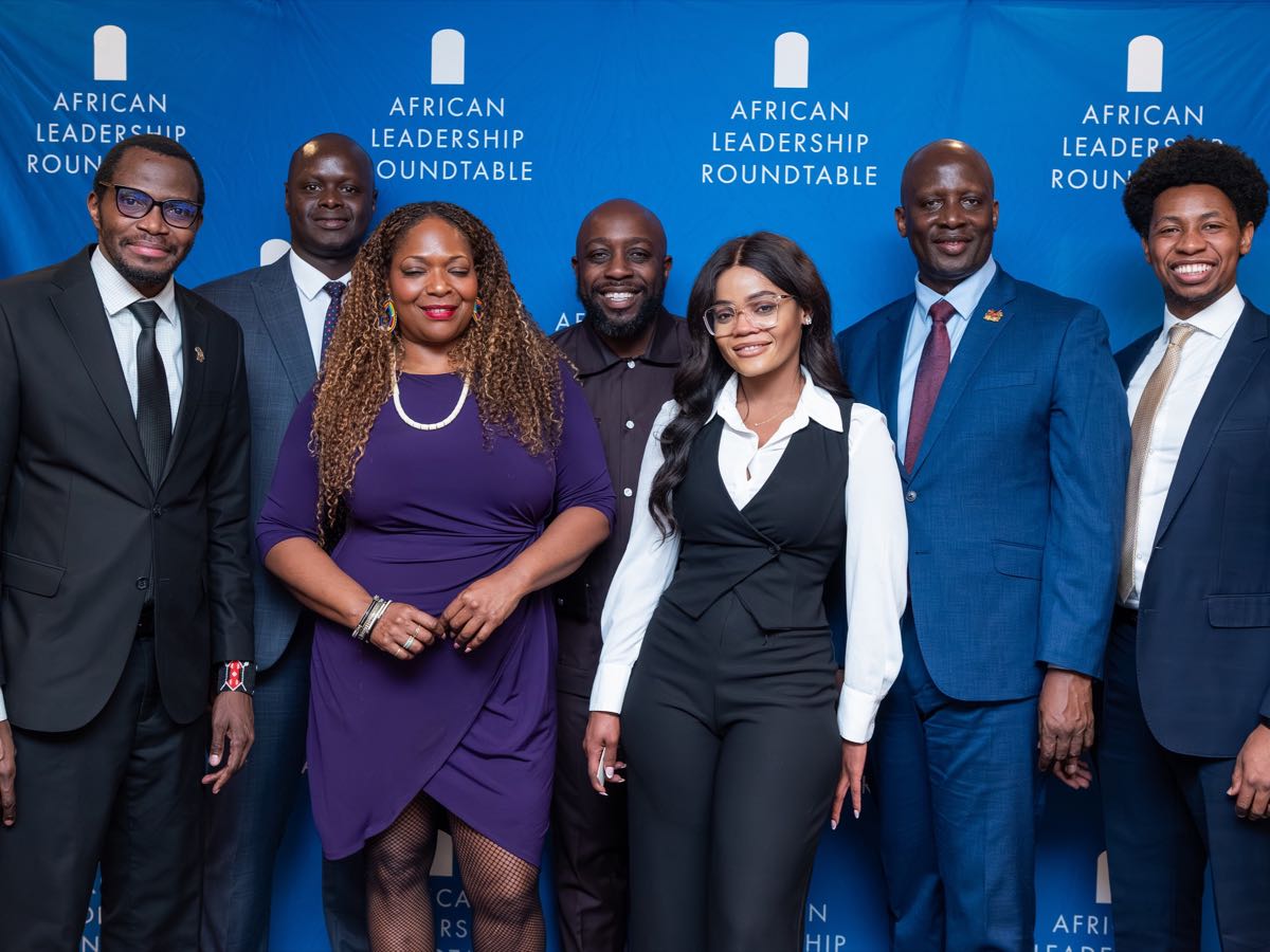 Guests gathered for a portrait beside the African Leadership Roundtable backdrop