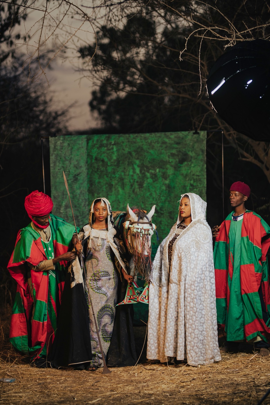 A cultural story in production, performers on set before a green screen